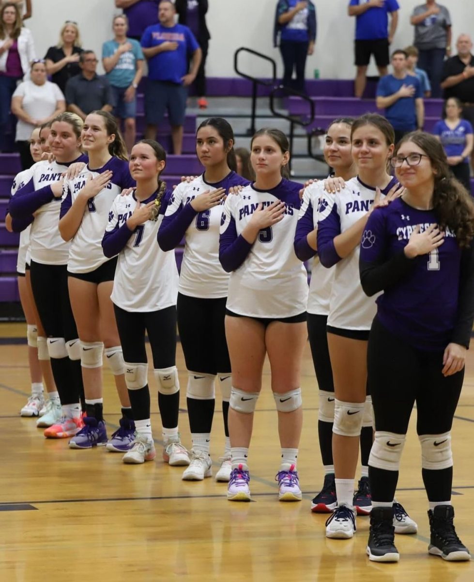 The Lady Panthers gather for the playing of the National Anthem