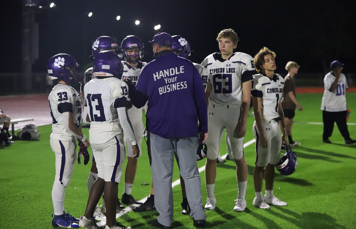 Coach Mendes confers with the boys on the sideline