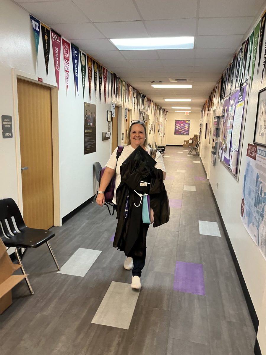 Ms. Atkinson can often be found with her camera bag and her hands full, ready to capture all the memories for the yearbook and help guide students toward their futures. Photo courtesy of J. Lessinger