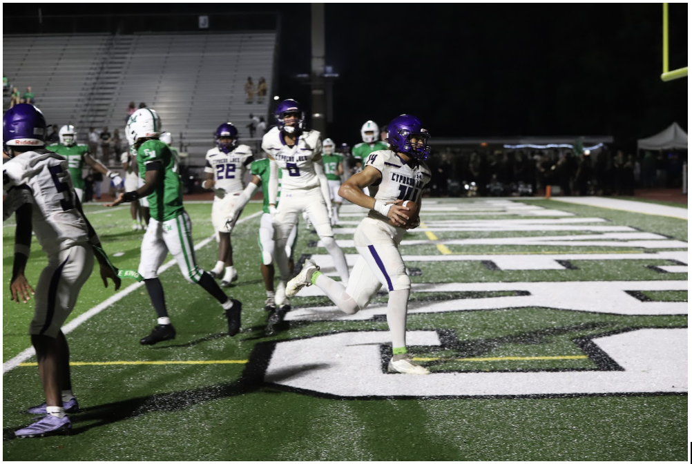 Jogging into the endzone, Zayne Kimpland, senior, scores one of his two touchdowns against Fort Myers High